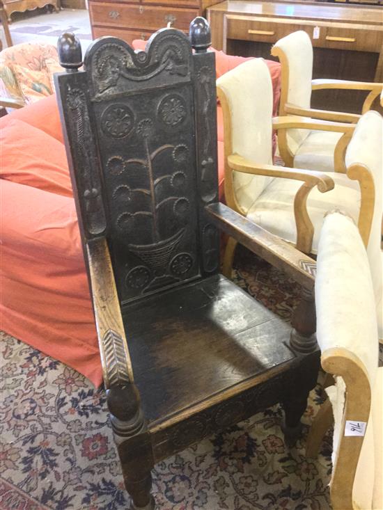 Oak high back elbow chair, carved with flowering plants, rosettes & tassels